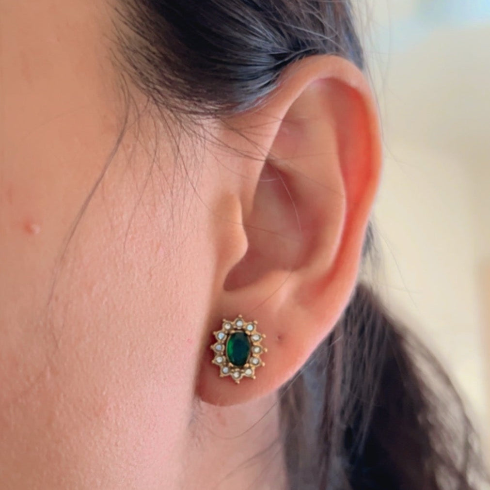 green stone earrings with crystal border on soft pastel background