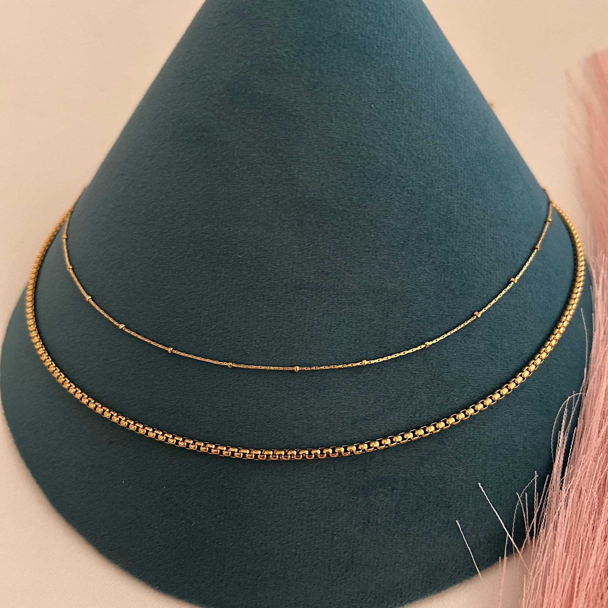 Two-layer gold waist band with fine bead chain and structured lower chain design.