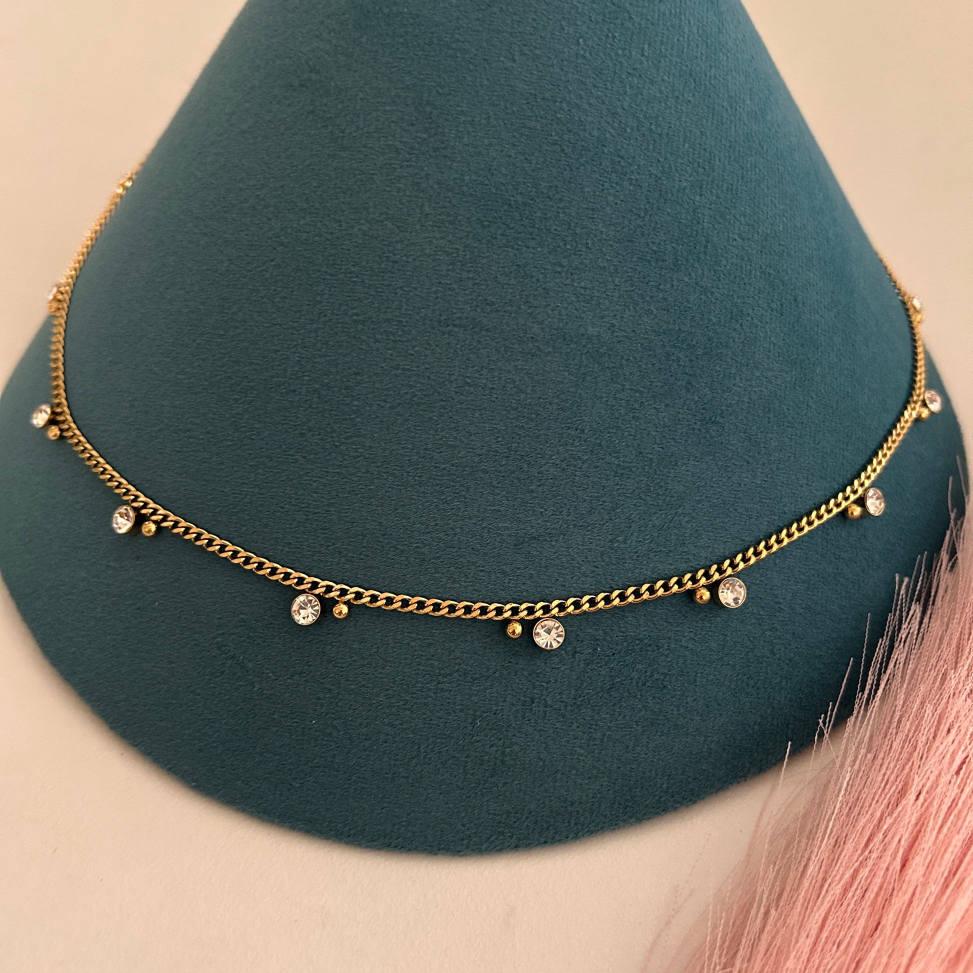 Slim gold waist band with bezel set crystal accents.