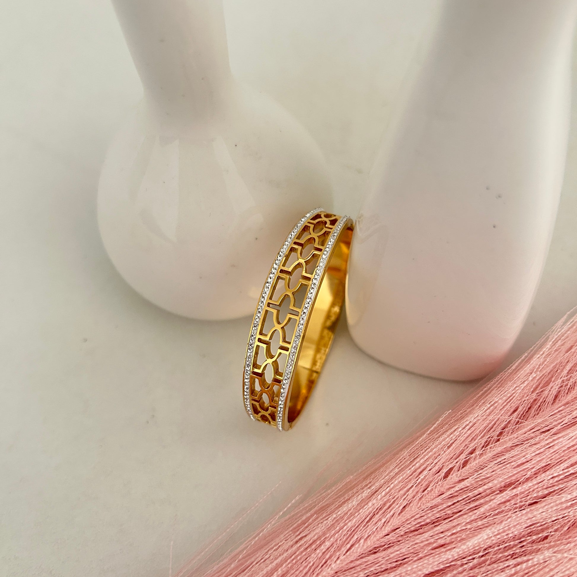 Gold honeycomb pattern bangle with crystal lining.