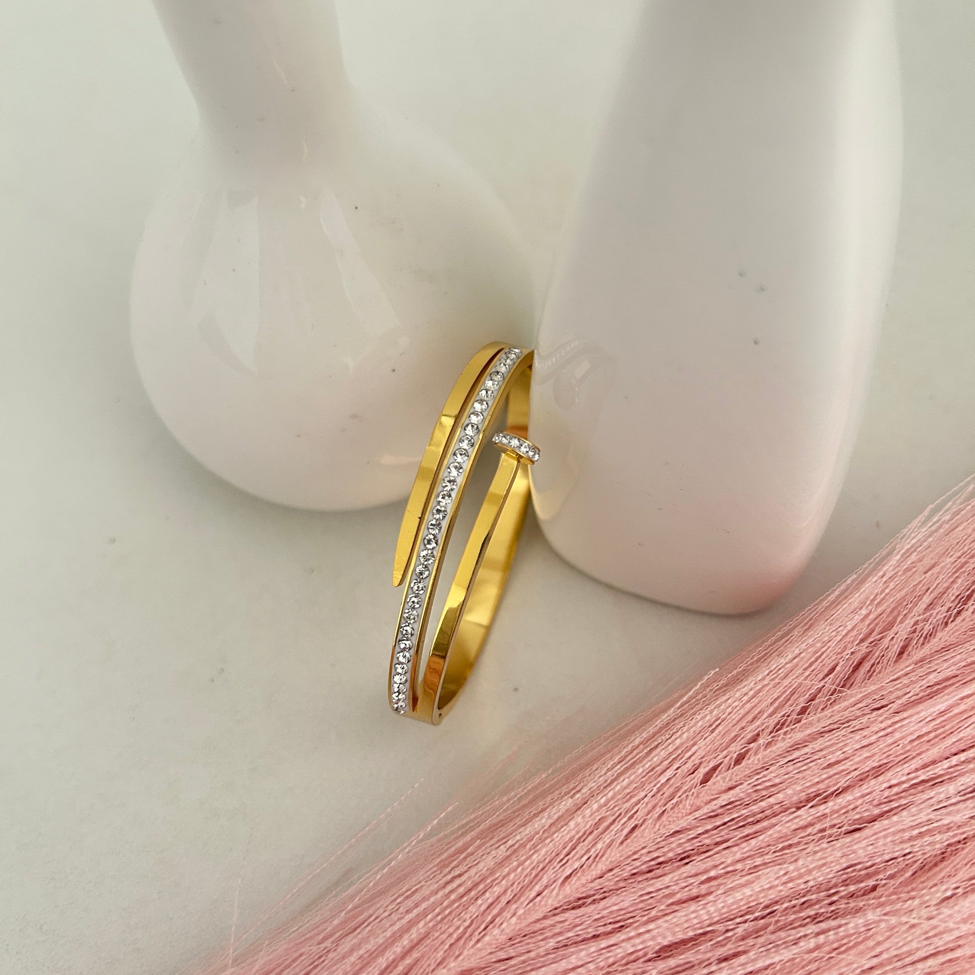 Gold open bangle bracelet with crystal strip.