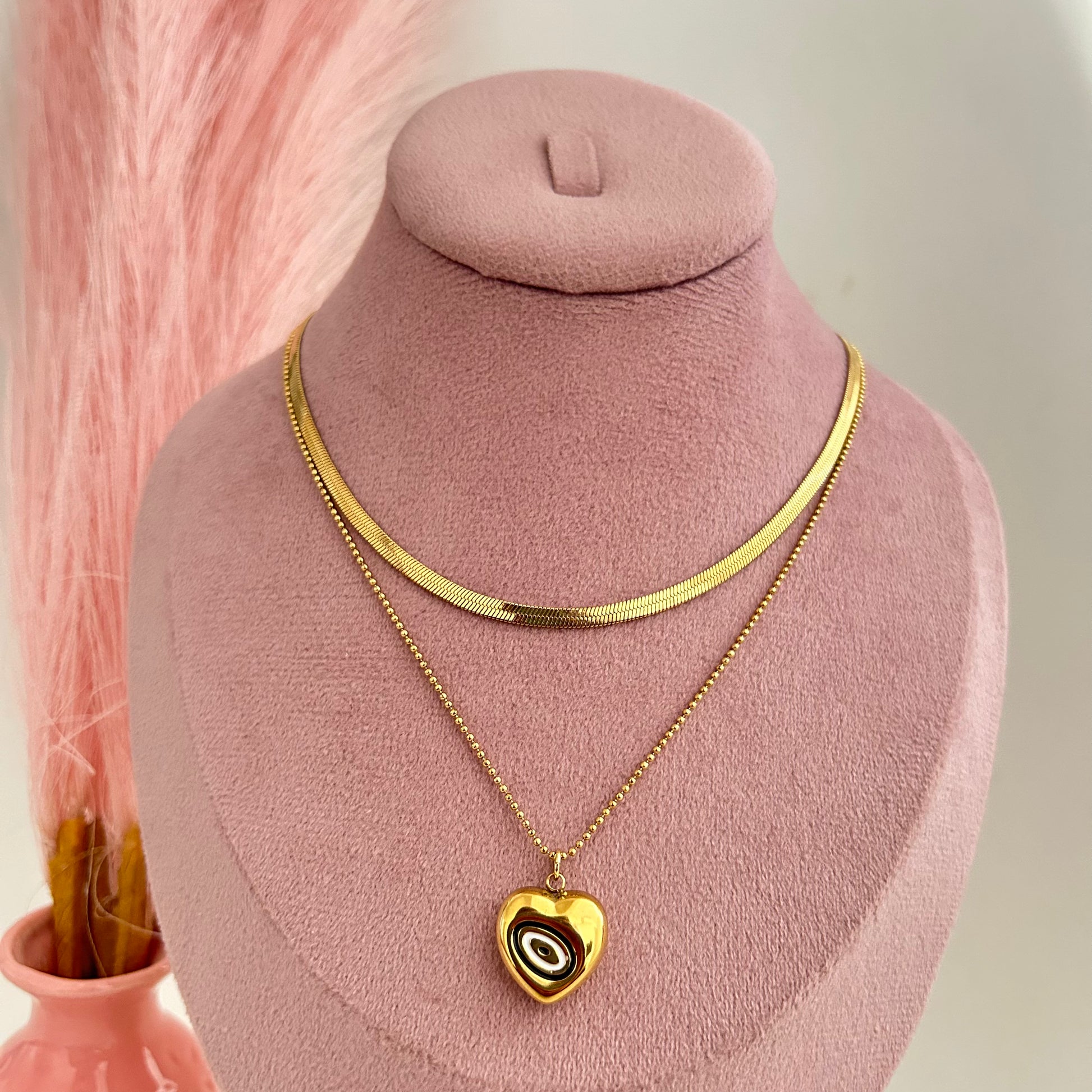 Gold layered necklace with artistic swirl heart pendant