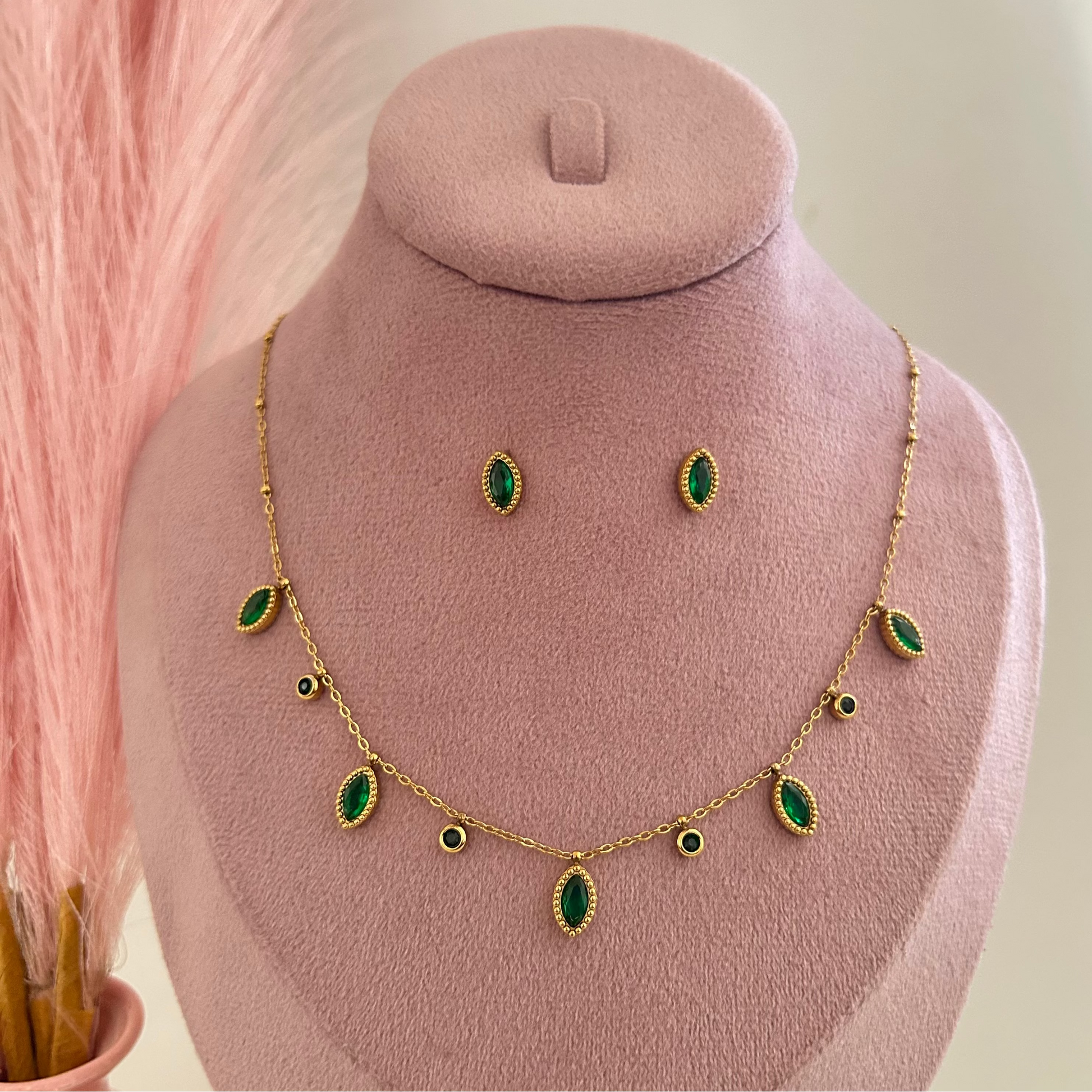 Gold necklace with long green gemstone drops and matching stud earrings