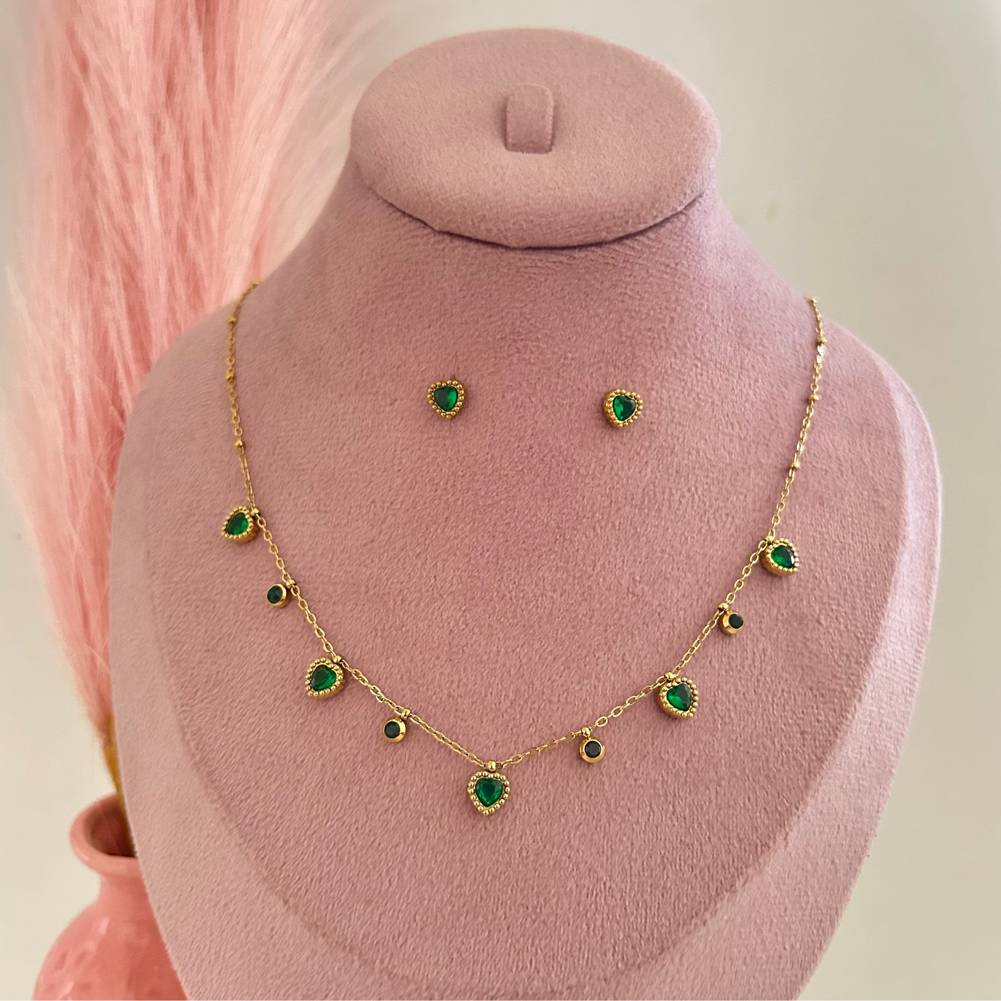 Gold necklace with small green charms and matching stud earrings