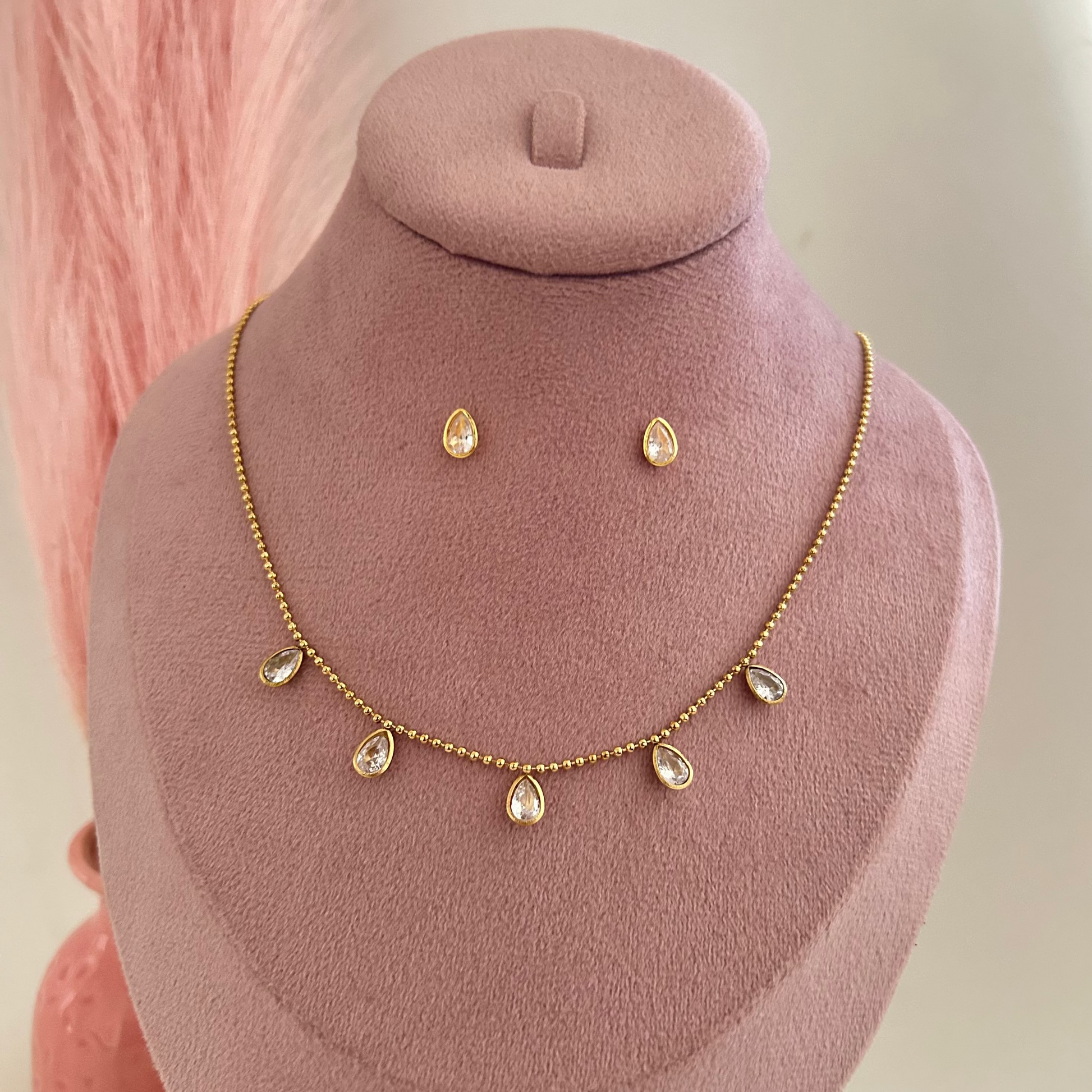 Gold necklace with small pearl drop charms and matching stud earrings