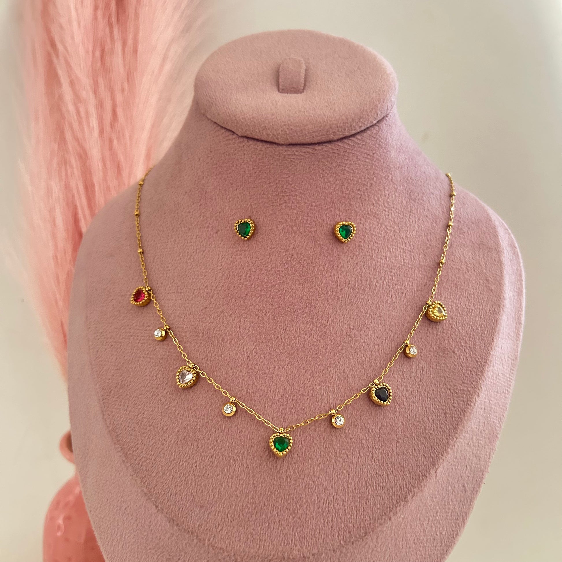 Gold necklace with green center drop and small charms with matching earrings