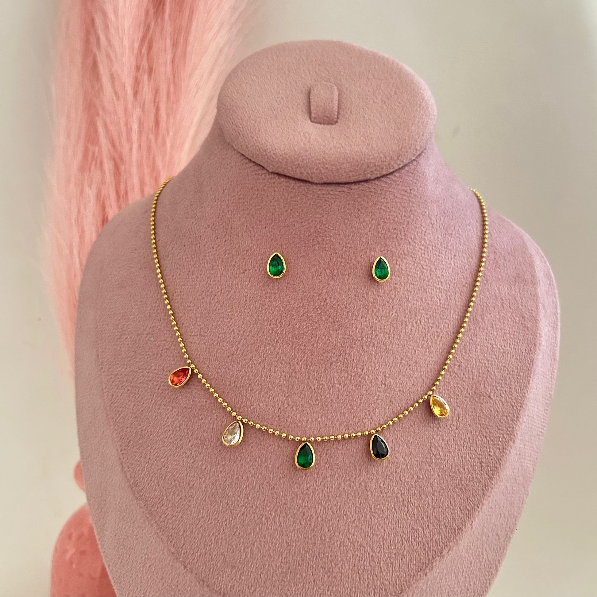 Gold necklace with small multicolor drops and green stud earrings