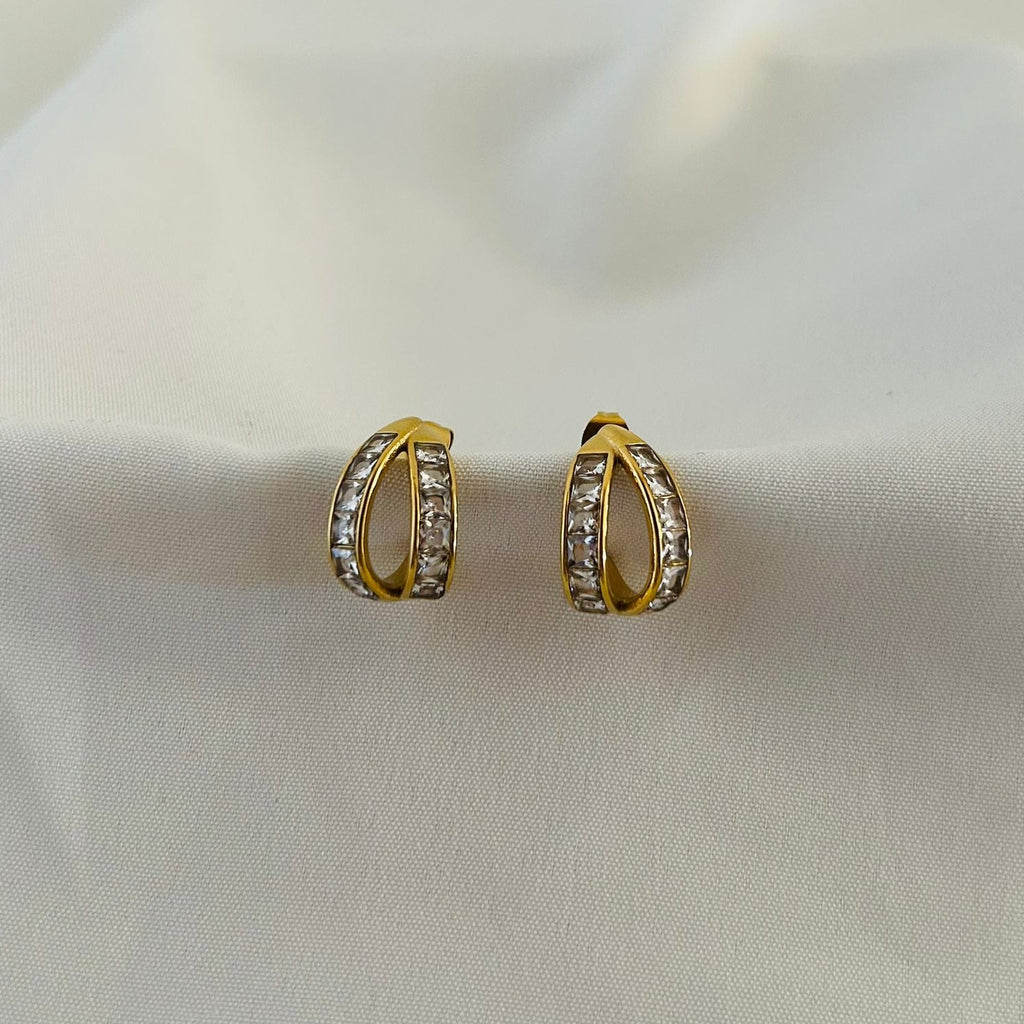 Modern gold hoops with dual curve and crystal detailing.