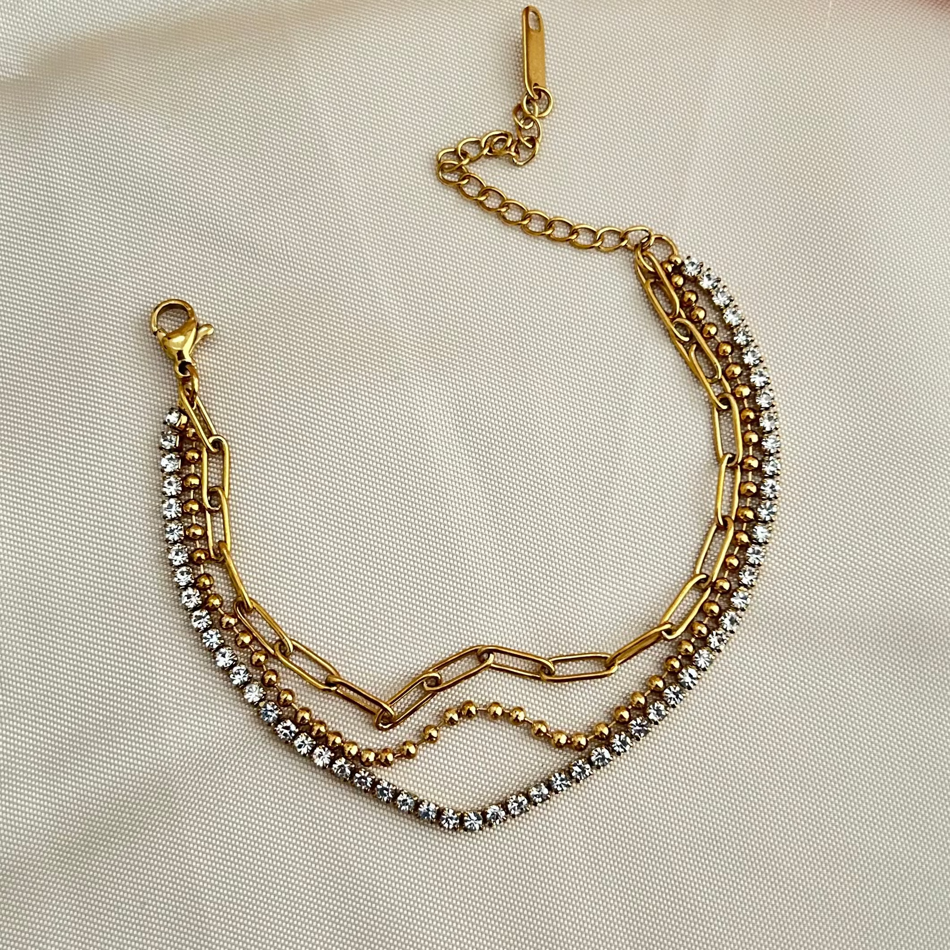 Multi-layer bracelet with gold chain links and crystal detailing